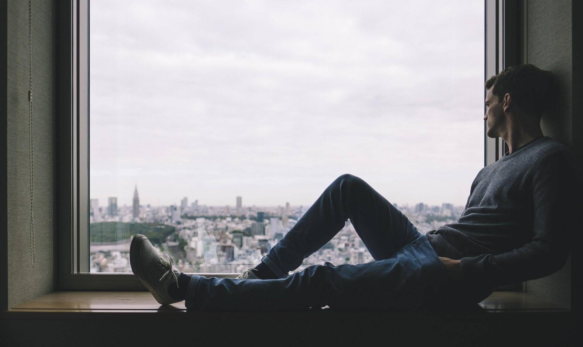 man sitting in window
