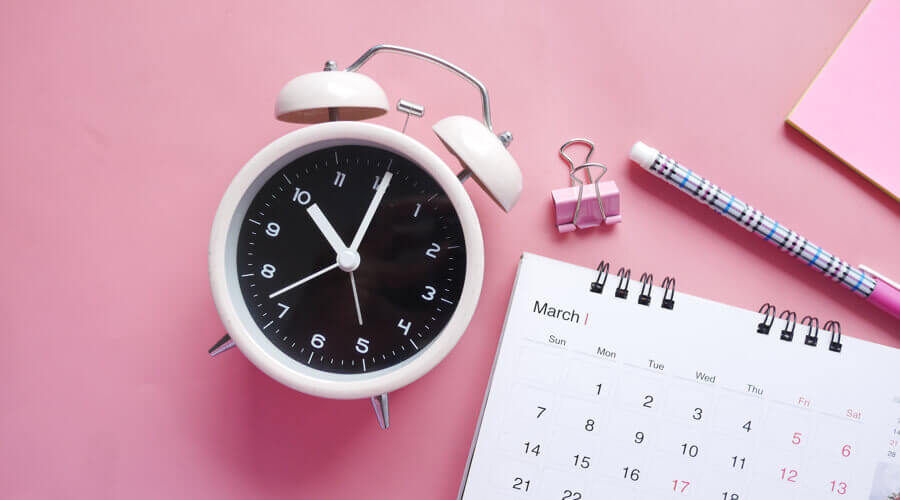Pink alarm clock and calendar