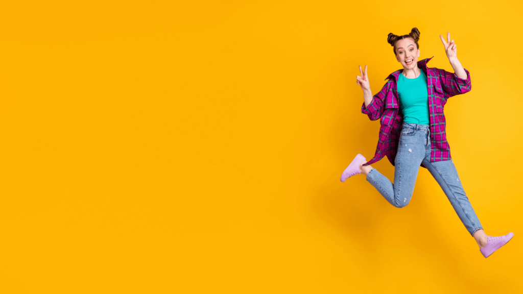 Woman jumping easily with a yellow background